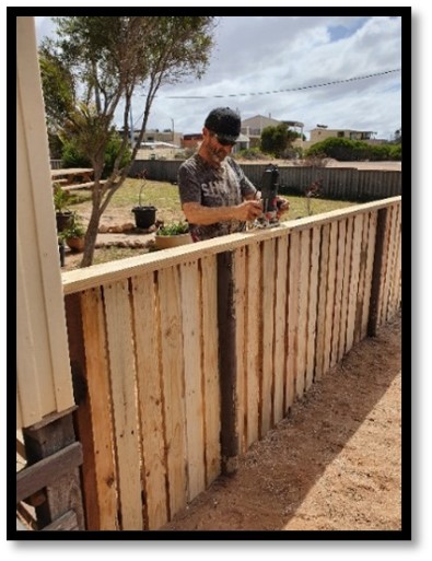 Jamie building a fence