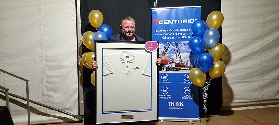 Sean Challis with the framed polo shirt from Carnar-Fin fishing competition 